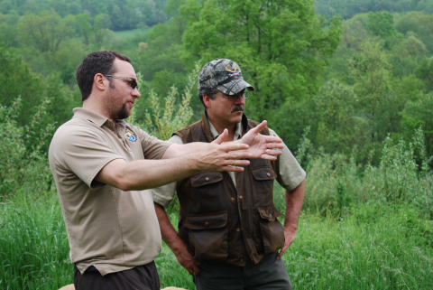 A biologist and a landowner plan a young forest and shrubland habitat project.