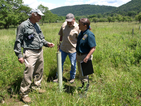 image of biologists and landowner